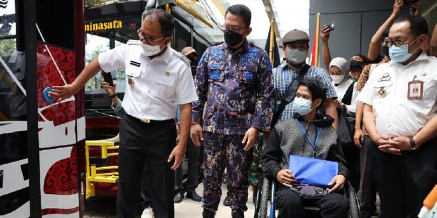 Transport sector employees check bus in Indonesia