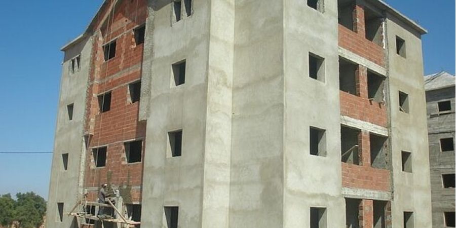 A person standing next to a building