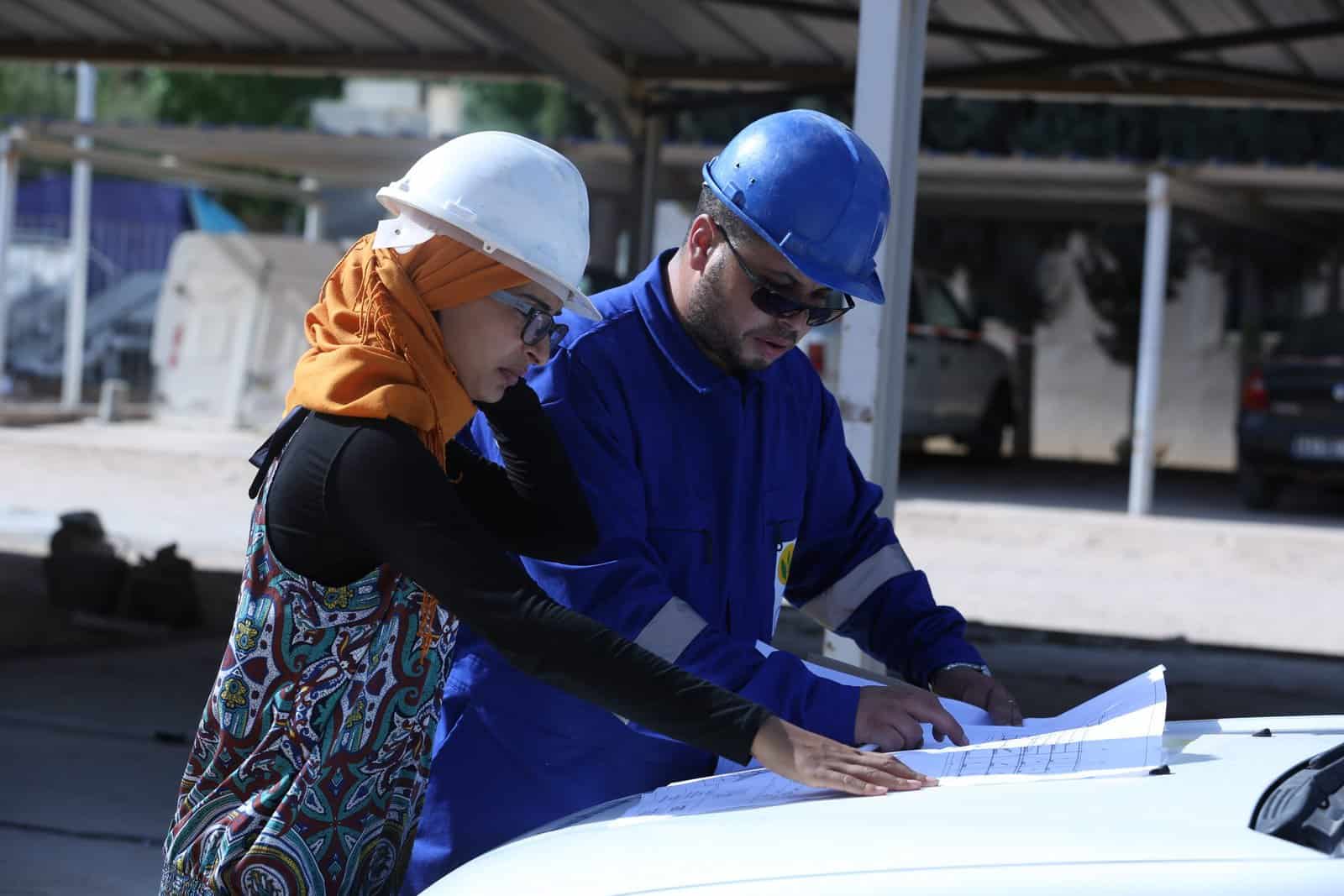 A woman and a man analyse a project paper.