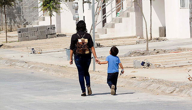 Mother and son walking hand in hand