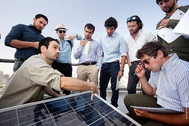 Group of men being shown proper use of photovoltaic technology
